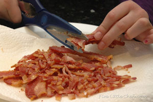 Cutting bacon with kitchen scissors