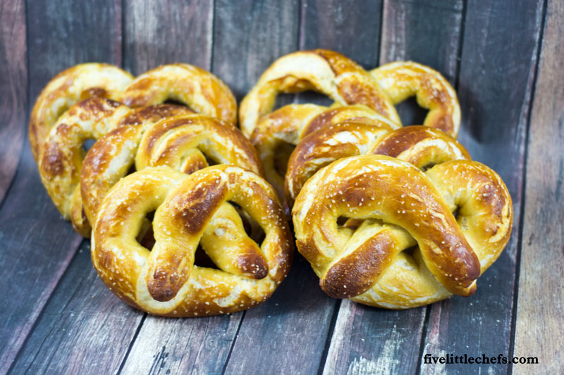 This easy homemade buttery soft pretzels recipe is loved by many! We have made it easy to understand how to make these with step by step instructions.They taste just like the mall but made at home for a great snack. fivelittlechefs.com